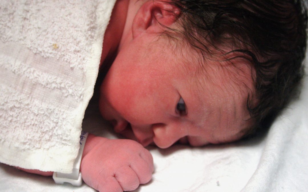 Newborn baby covered with a towel